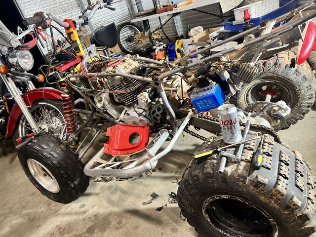 ATV quad disassembled in shop for engine and suspension work