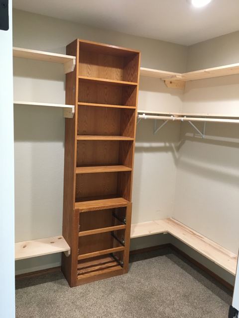 Custom walk-in closet with built-in shelving tower and hanging rods