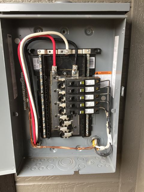 Electrical panel interior showing breaker wiring and grounding
