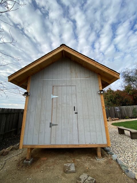 Backyard shed front view with door and hardware