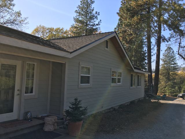 House exterior with new siding and shingled gable roof